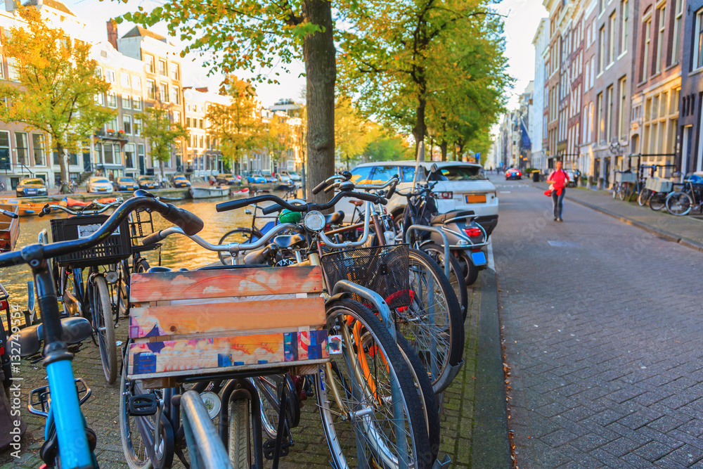 Bicycles with Amsterdams cityscape at sunset, The Netherlands Bicycles with Amsterdams cityscape at sunset, The Netherlands