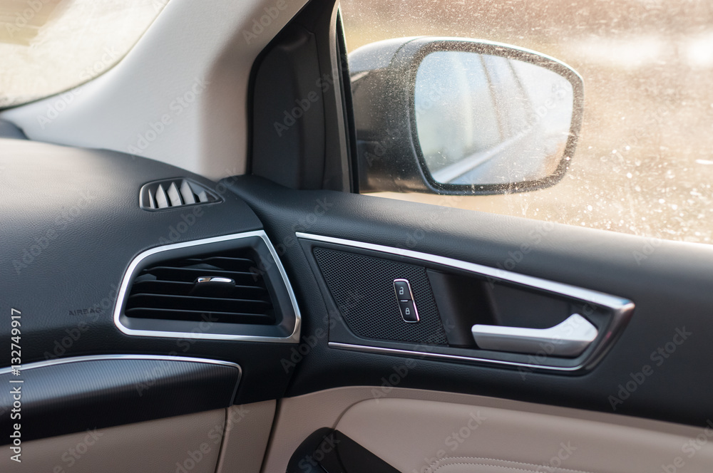 Car interior, dashboard, mirror and door handle. Door lock and unlock buttons