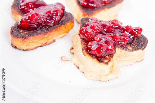 Heart shaped pancakes with cowberry jam