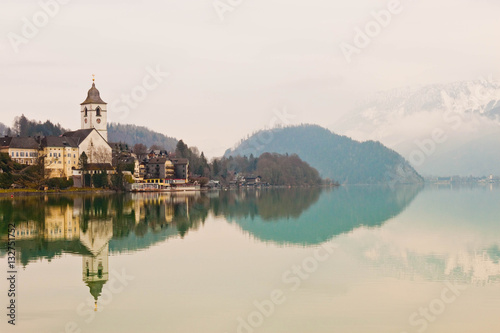 View of St. Wolfgang chapel and the village of St. Wolfgang  at Wolfgangsee lake, Austria © slowcentury