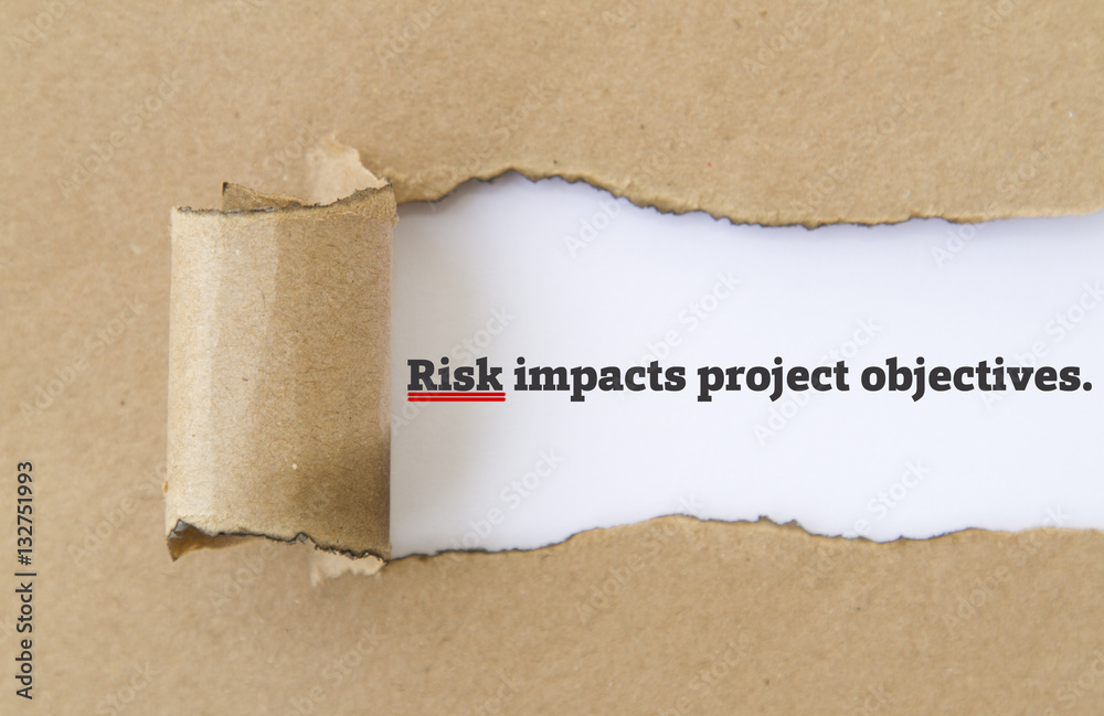 RISK impacts project objectives message written under torn paper.