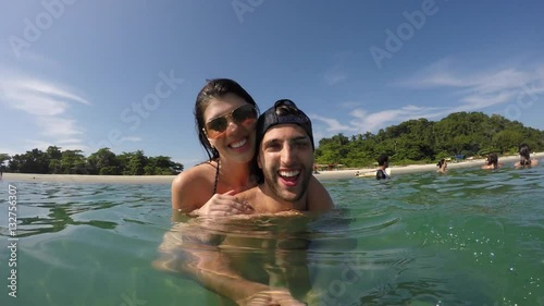 Couple taking a selfie and having fun in a Beach in Brazil