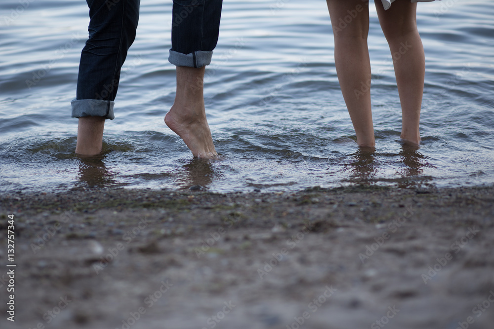 lovers playing in the water with their feet