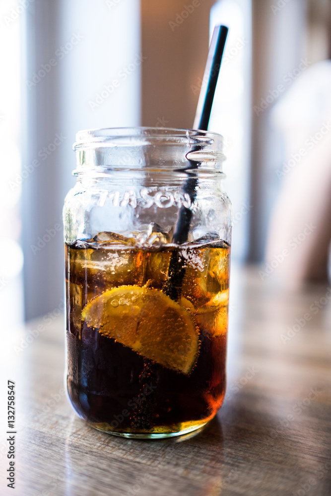 iced tea drink with lemon in a glass bottle