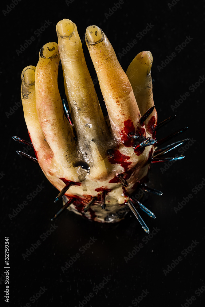wax hand sculpture with nails and blood