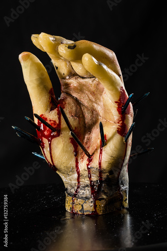 wax hand sculpture with nails and blood