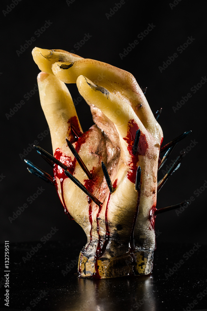 wax hand sculpture with nails and blood