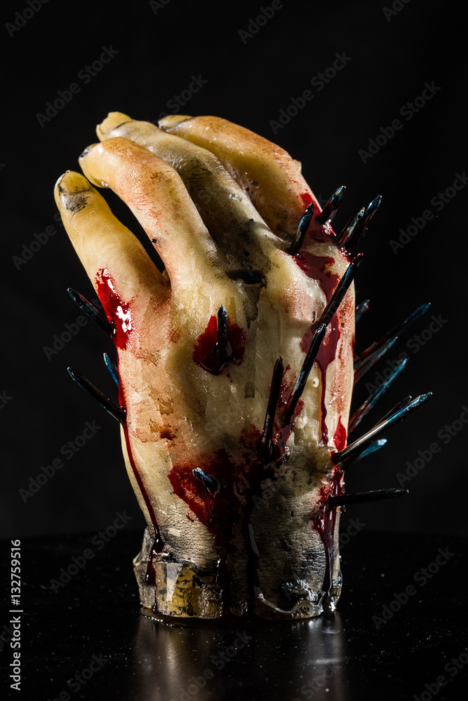 wax hand sculpture with nails and blood