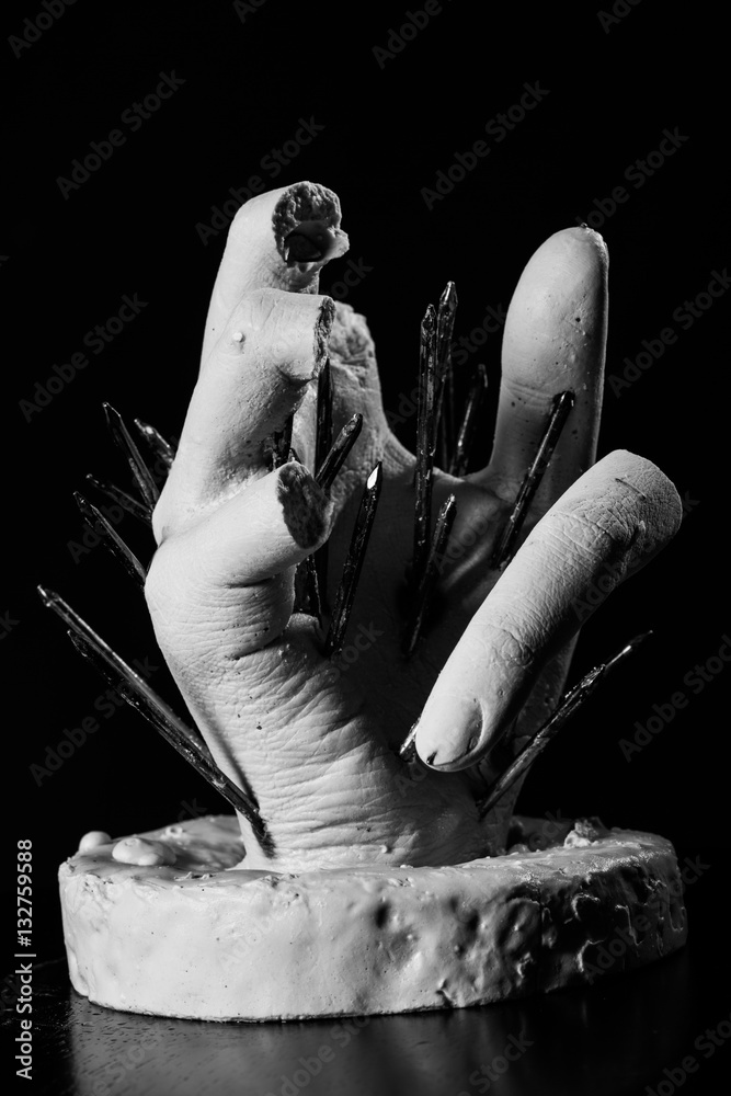 plaster hand sculpture with nails painful