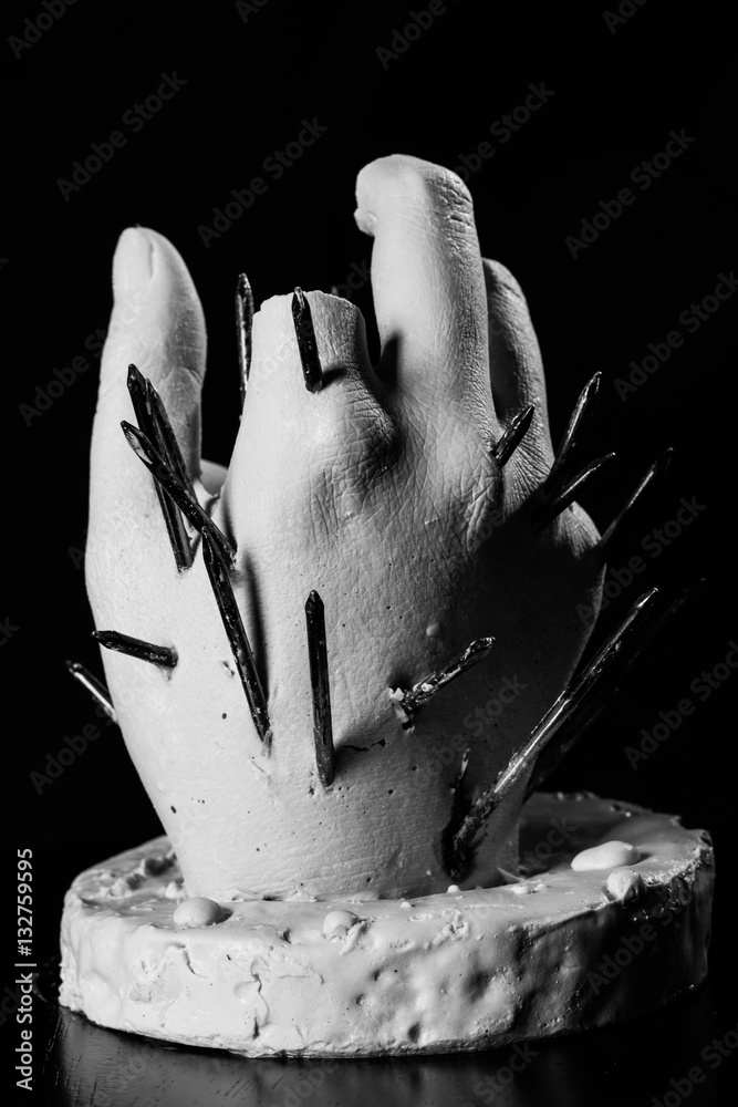 plaster hand sculpture with nails painful