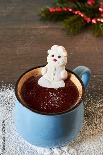 Vintage mug with hot chocolate and melted marshmallow snowman