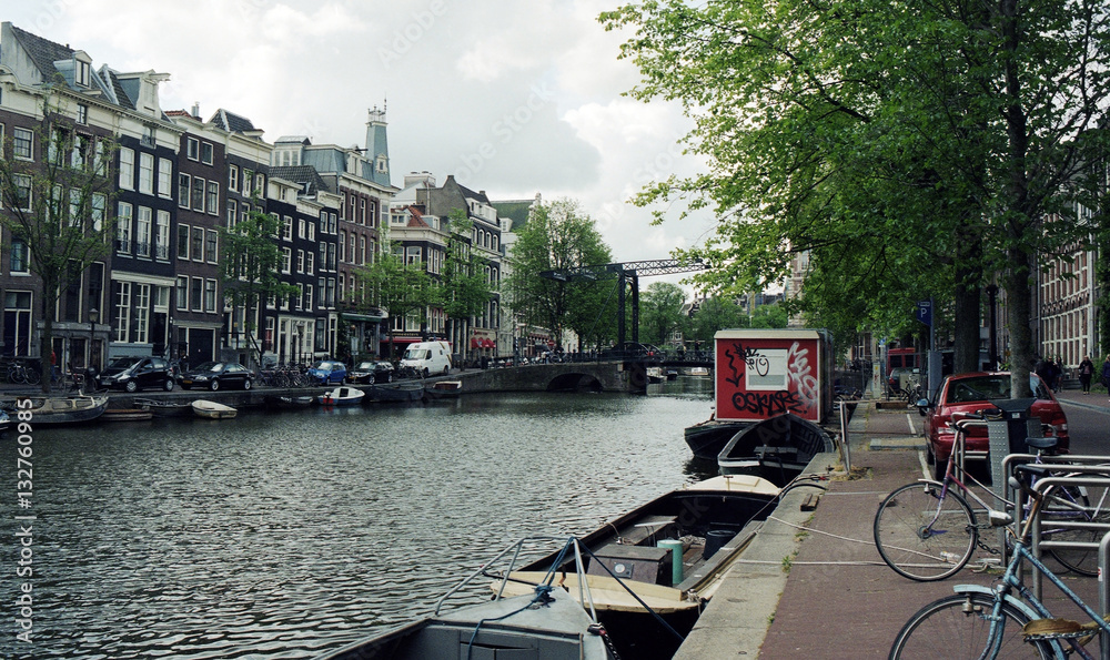 Netherlands, Amsterdam. Types of cities, buildings, canals and boats. Views on the water background. Amsterdam in the spring.