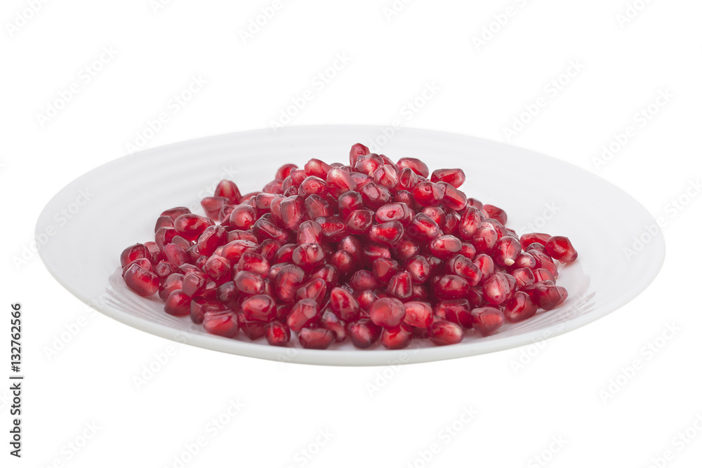pomegranate grains on a white plate pomegranate grains on a white plate