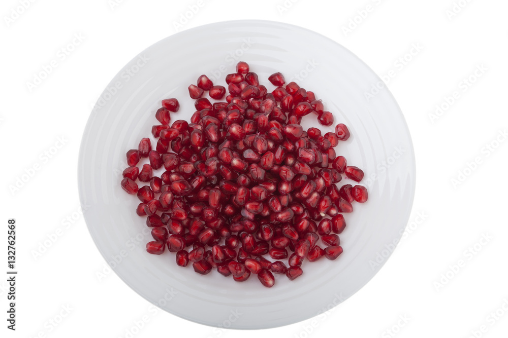 top view of pomegranate grains on a white plate isolated on white background top view of pomegranate grains on a white plate isolated on white background