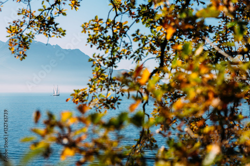 Boat in ocean with mountain background in fall