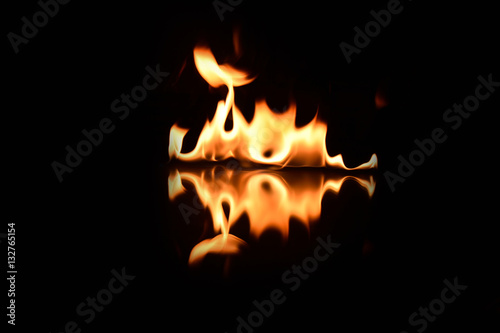 flames on a black background with mirror reflection