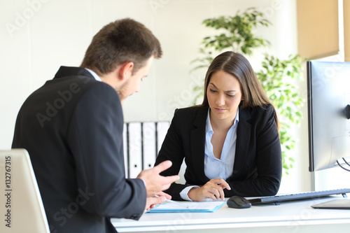 Fotografie Salesman trying to convince to a doubtful client