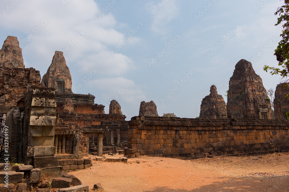 Angkor Wat temple ruins on the sand desert with blue sky hot atmosphere