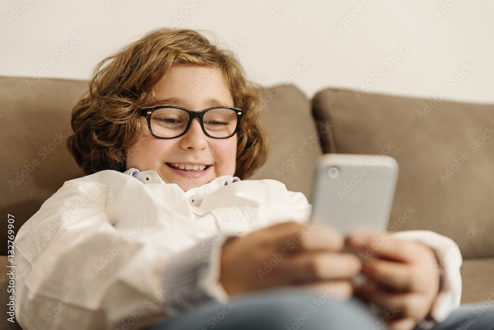 Child boy using his mobile phone. Child boy using his mobile phone.