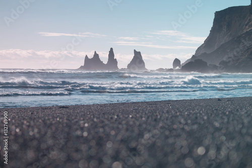 Iceland Vik coast on the black beach ocean shore with waves in winter and rock formations