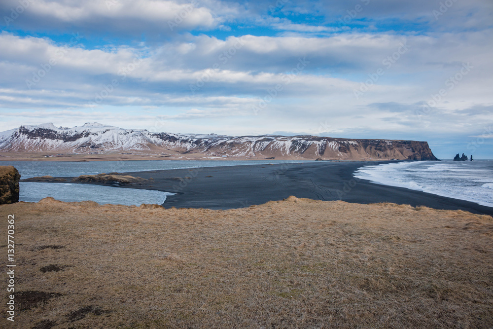 Iceland Vik south coast panorama with mountains and brown meadow in winter Iceland Vik south coast panorama with mountains and brown meadow in winter