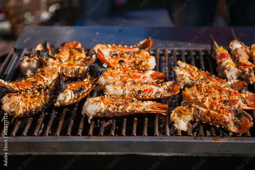 Freshly grilled giant lobsters. Lobster bbq, no claws. Street food.