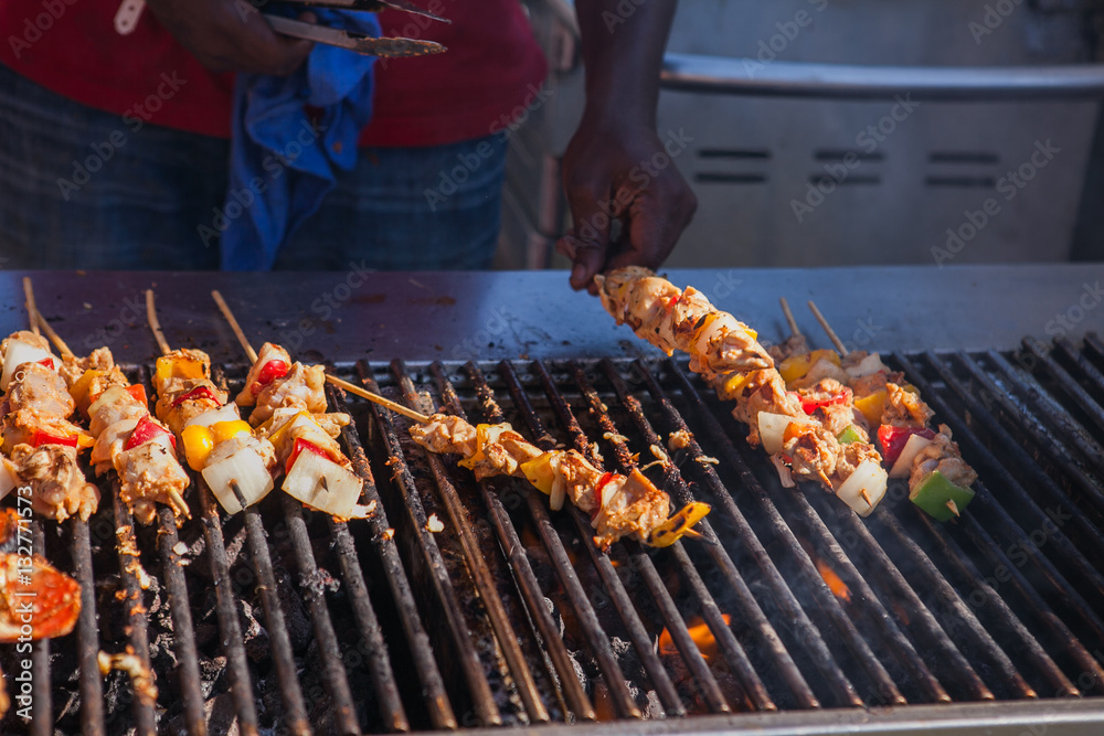 Street food on a grill. Grilled meat stick