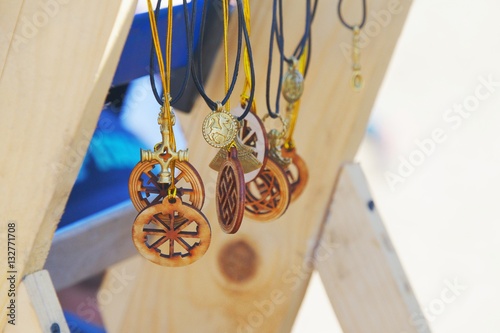 Slavic amulets made of wood and handmade metal, close-up photo