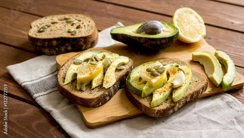 making sandwiches with avocado healthy organic food top view