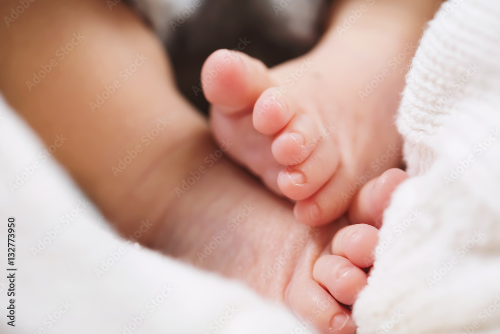 Baby feet peaking out of a blanket Baby feet peaking out of a blanket