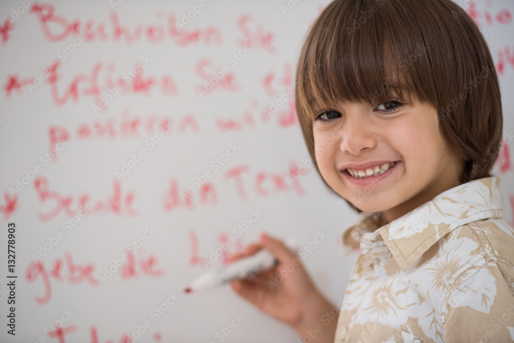 Kid writing on white board Kid writing on white board