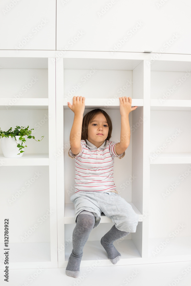 Kid in shelves at home