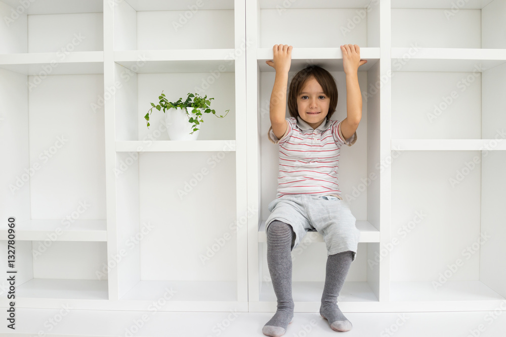 Kid in shelves at home Kid in shelves at home