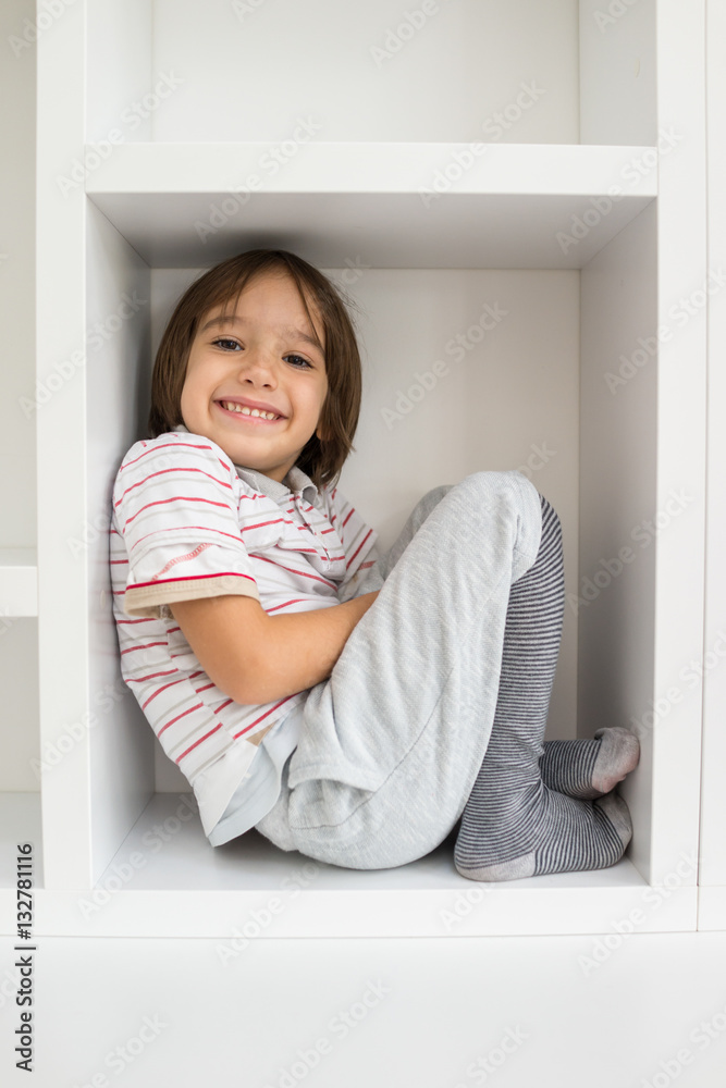 Child in shelf inside living room