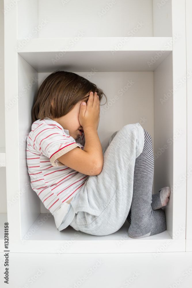 Child in shelf inside living room Child in shelf inside living room
