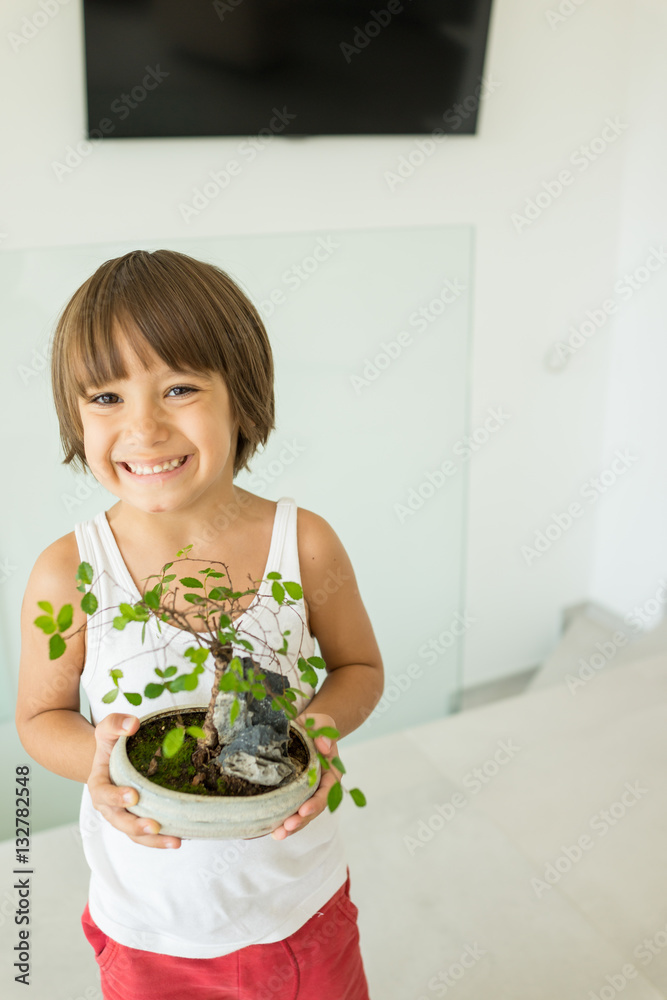 Kid holding plant growing organic herbs for cooking at home heal