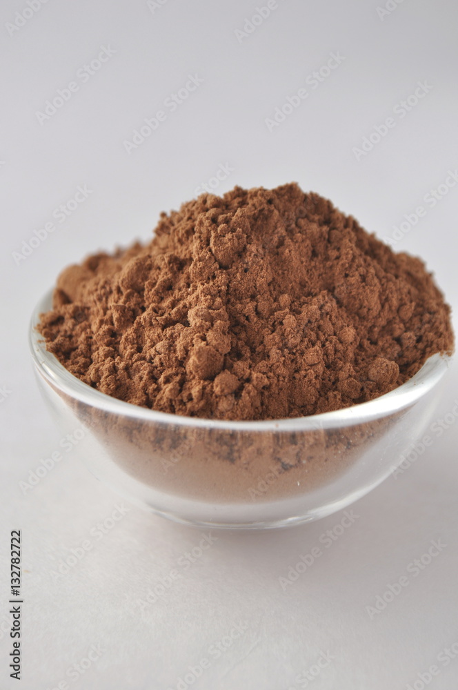Raw cocoa (Theobroma cacao) powder in a glass bowl, closeup on white background
Raw cocoa (Theobroma cacao) powder in a glass bowl, closeup on white background