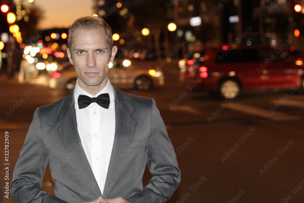 Dapper gentleman outside at night in the city