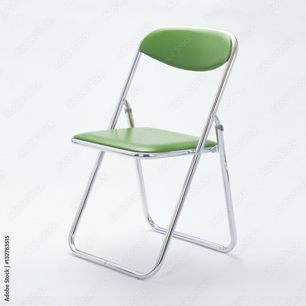 Green folding chair isolated on white background.
