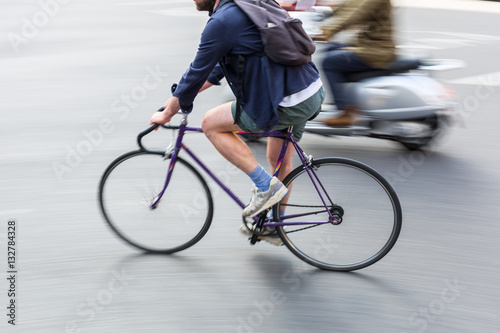 bicycle rider in city traffic in motion blur