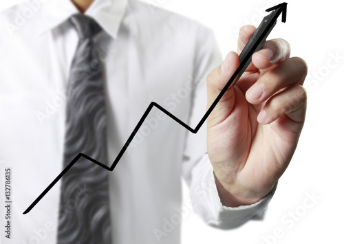 Businessman drawing graphics growing graph.
