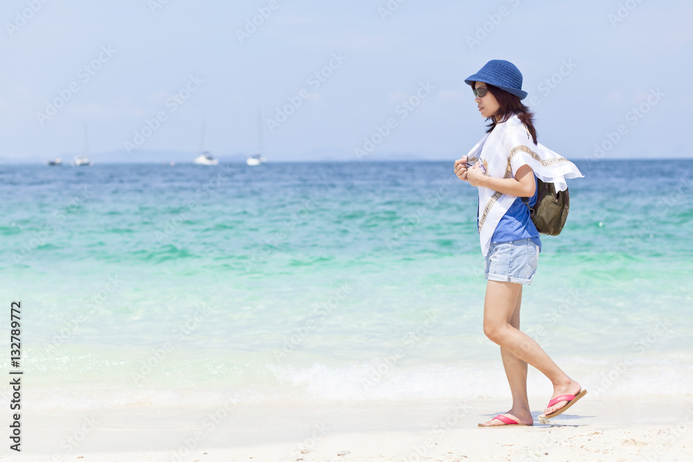 A girl walk and relax on the beach at Phuket island, Thailand