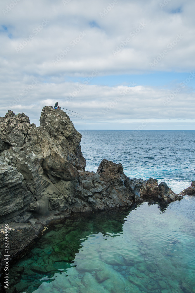 Fisherman at the natural pool Charco De La Laja, at the north of Tenerife, Canary Islands, Spain