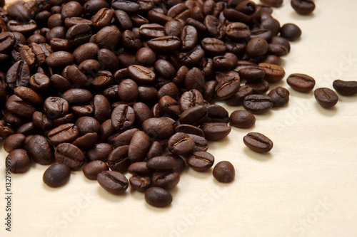 Coffee beans on the wood background.
