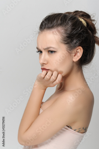 Girl looks thoughtfully. She has a clean well-groomed skin