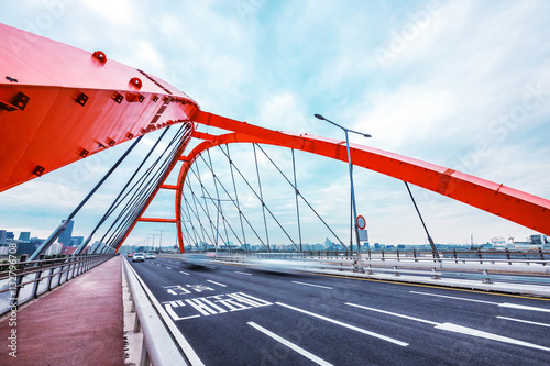 bridge with abstract steel constructions in seoul in cloud sky photo