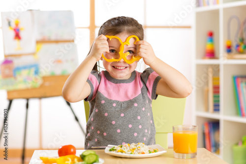 Funny little child eats hea...