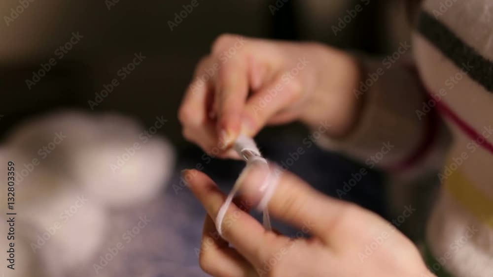 Female's hands with knitting needles while knitting. Female's hands with knitting needles while knitting.