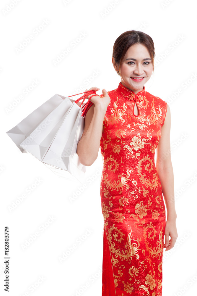 Asian girl in chinese cheongsam dress with shopping bag. Asian girl in chinese cheongsam dress with shopping bag.