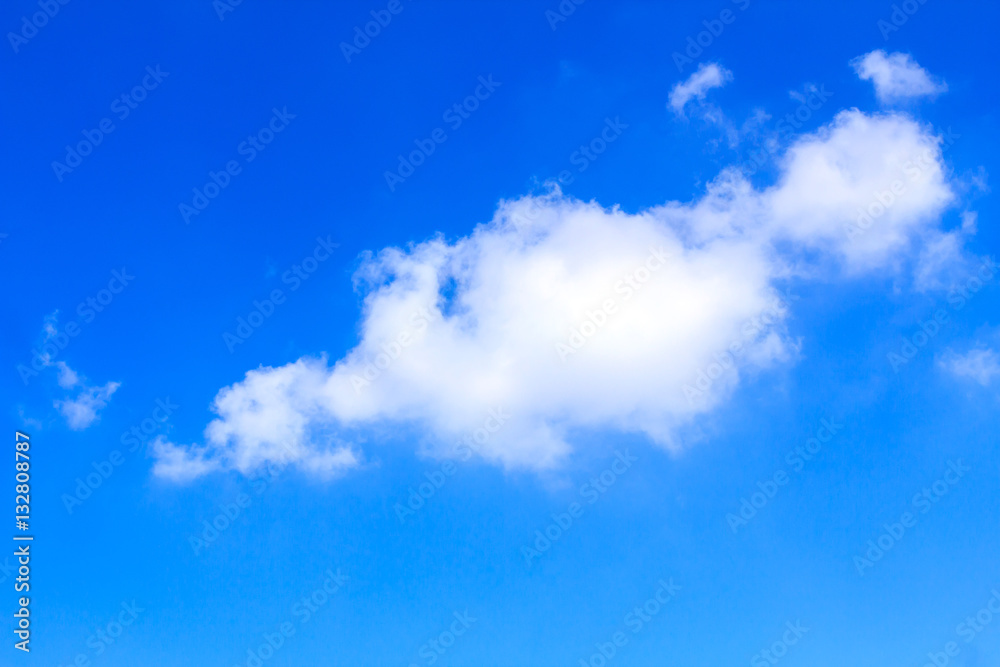 Blue sky background with white clouds on sunny summer or spring day.